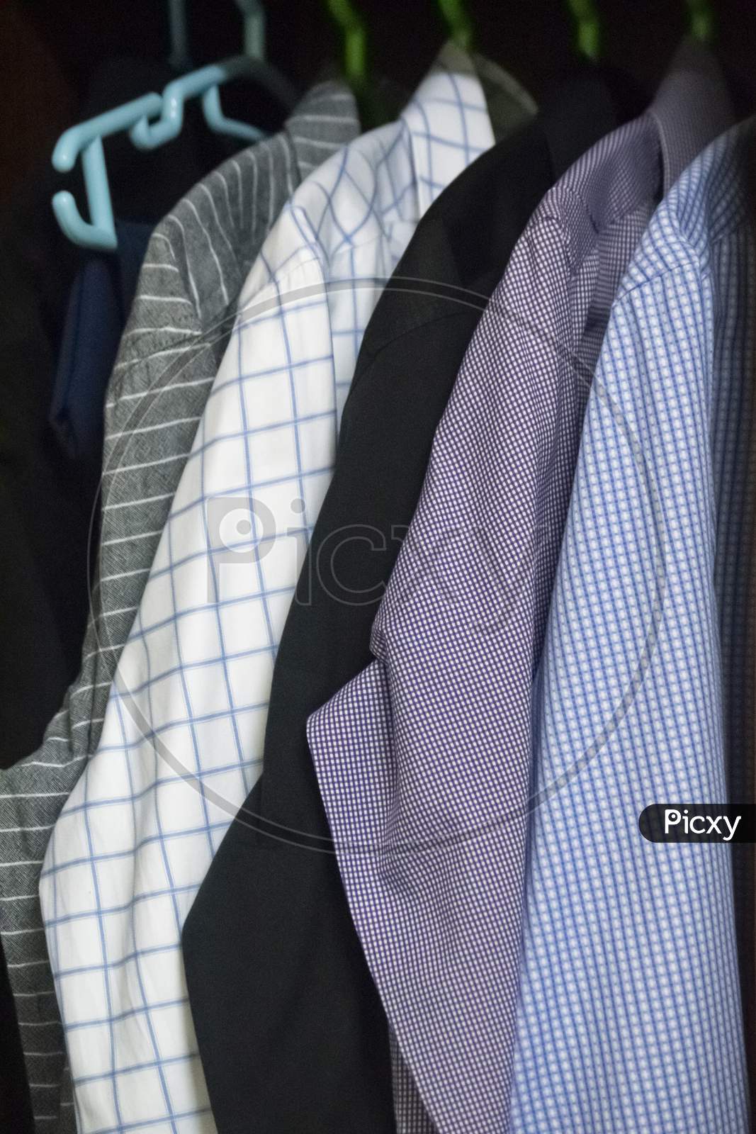 Mix Of Men'S Shirts Hanged In Wardrobe