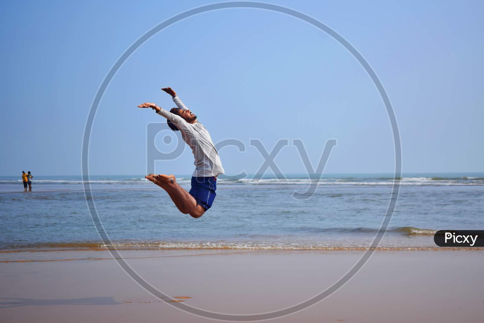 Young Man Jumping On The Beach, Beautiful View
