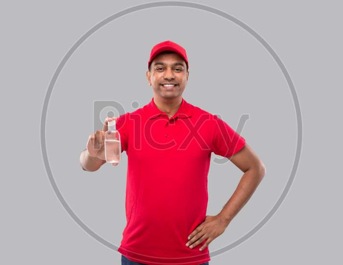 Indian Delivery Man Holding Hands Sanitizer. Hands Antiseptic. Man In Red T Shirt. Health, Isolation Concept