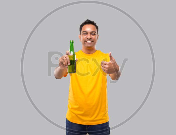 Indian Man Holding At Beer From Beer Bottle Showing Thumb Up Isolated.