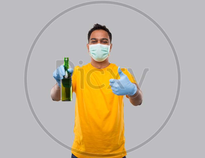 Indian Man Holding Beer Bottle Showing Thumb Up Wearing Medical Mask And Gloves Isolated.