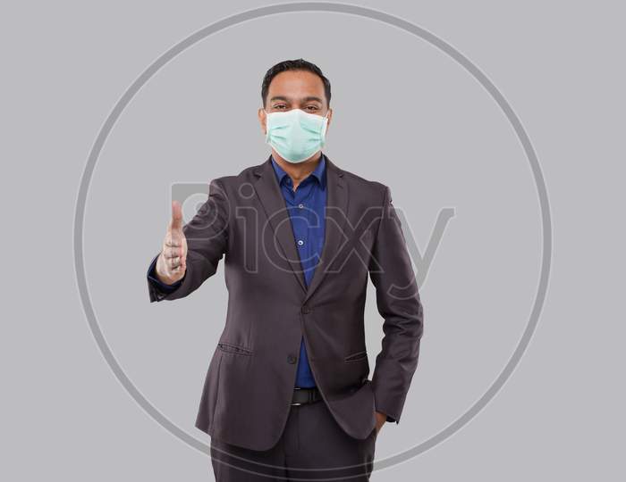 Indian Businessman Offering Hand To Shake Wearing Medical Mask. Greeting And Welcoming Gesture. Business Advertisement Concept. Businessman Hand Shake