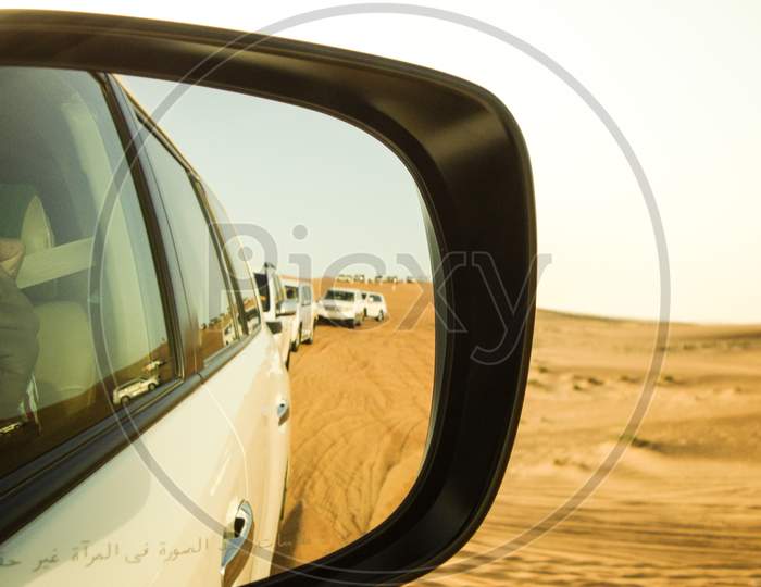 Desert Safari during summer month Point of View Looking through the mirror with cars lined up, Dubai, UAE