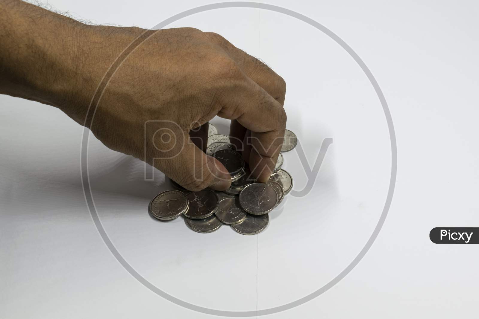 A Man Hand Taking Uae Currency Coins With White Background, Fils,