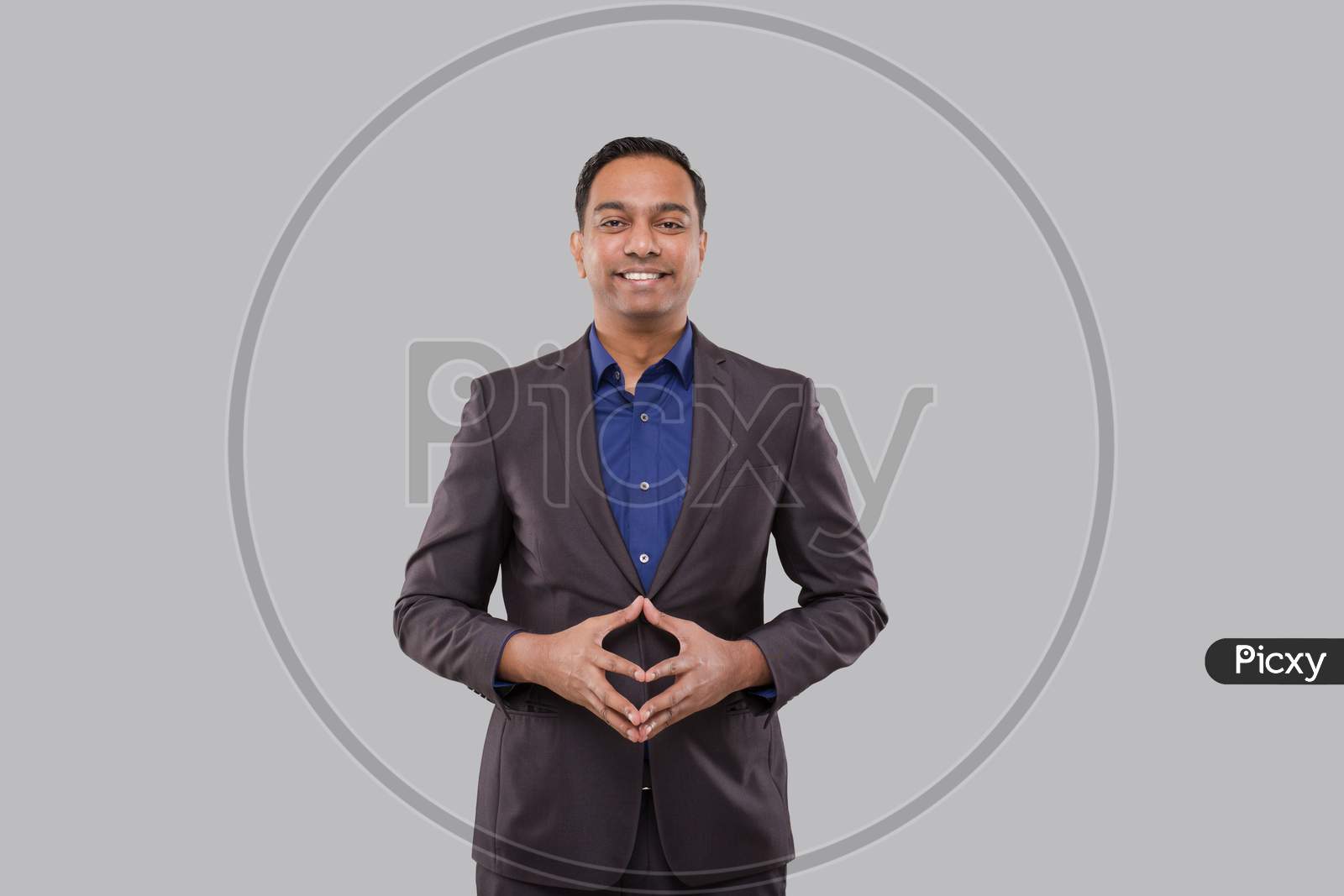 Businessman Smilling Hands In Front Of Chest Isolated. Indian Business Man Standing Business Pose