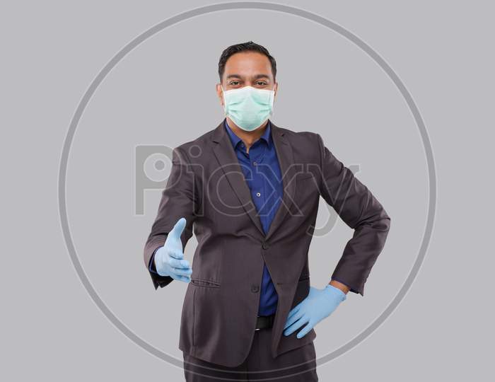 Indian Businessman Offering Hand To Shake Wearing Medical Mask And Gloves. Greeting And Welcoming Gesture. Business Advertisement Concept. Businessman Hand Shake