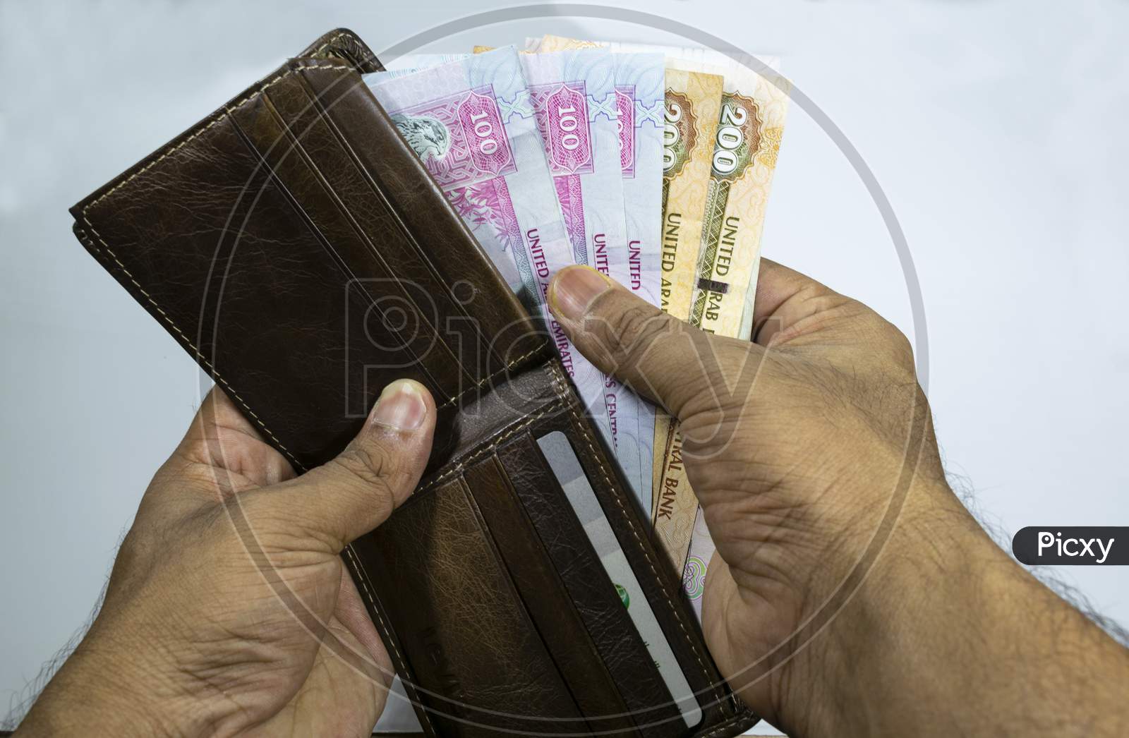 A Man Taking Dirhams From His Wallet With White Background