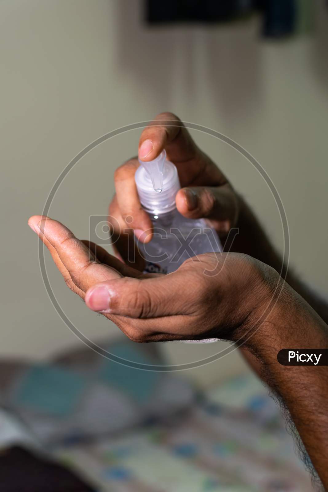 An Indian Man Taking Hand Sanitizer To His Hand To Prevent Corona Virus