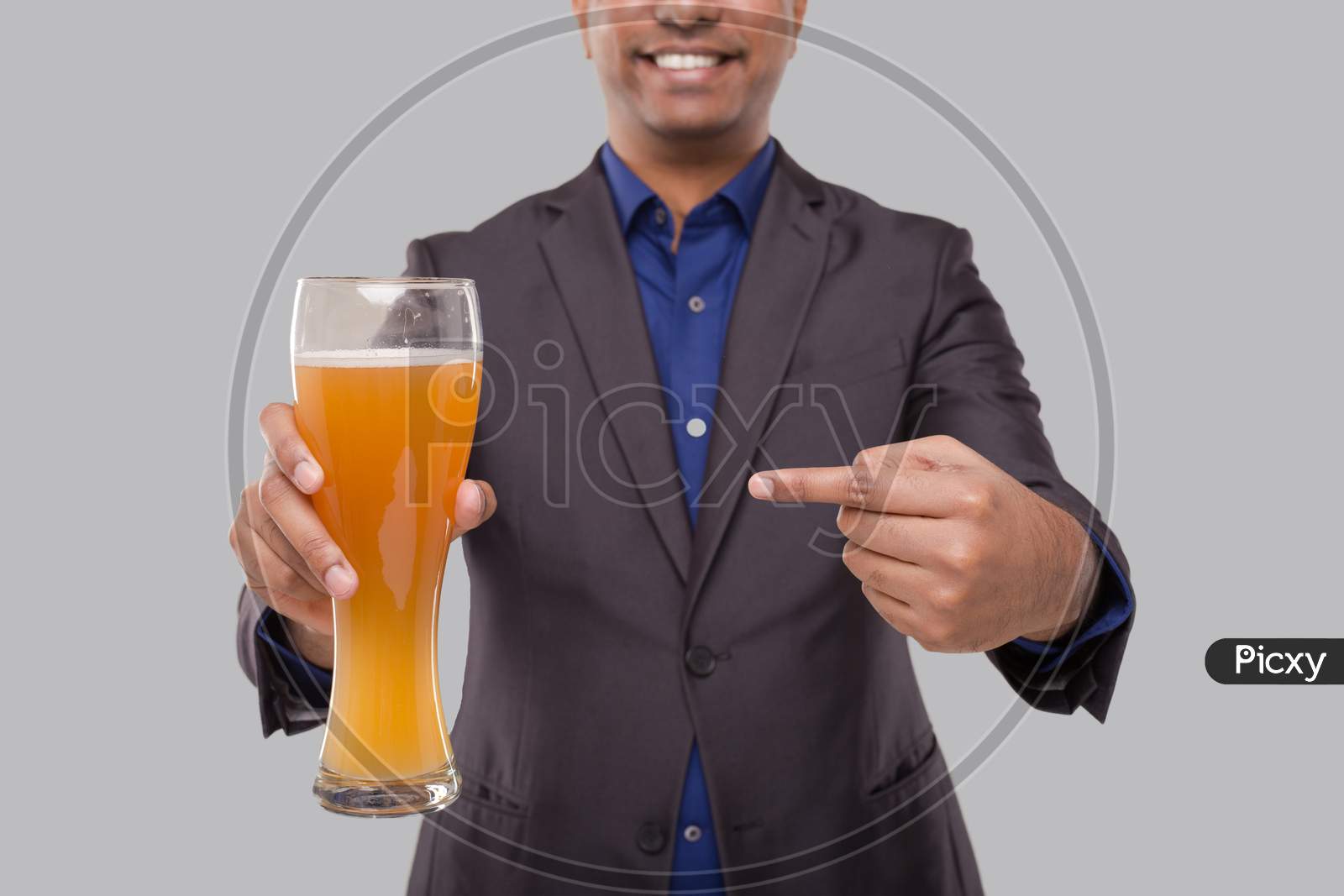 Businessman Pointing At Beer Glass. Indian Business Man With Beer In Hand Close Up