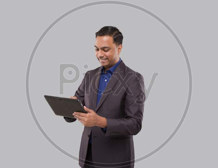 Businessman Using Tablet Green Screen Isolated. Indian Business Man With Tablet In Hands. Online Business Concept