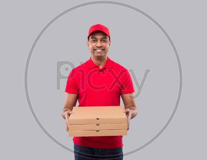 Delivery Man With Three Pizza Box In Hands Isolated. Red Tshirt Indian Delivery Boy.
