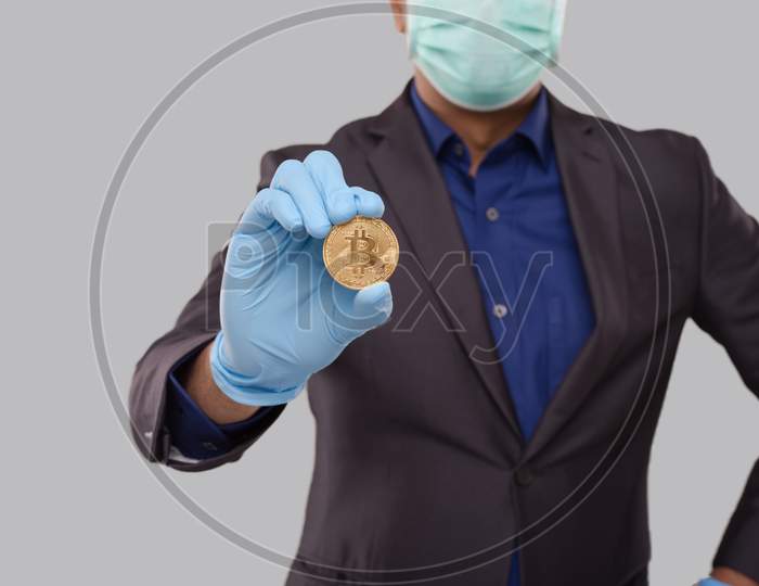Businessman Showing Bitcoin Wearing Medical Mask And Gloves. Business Man Cypto Currency.
