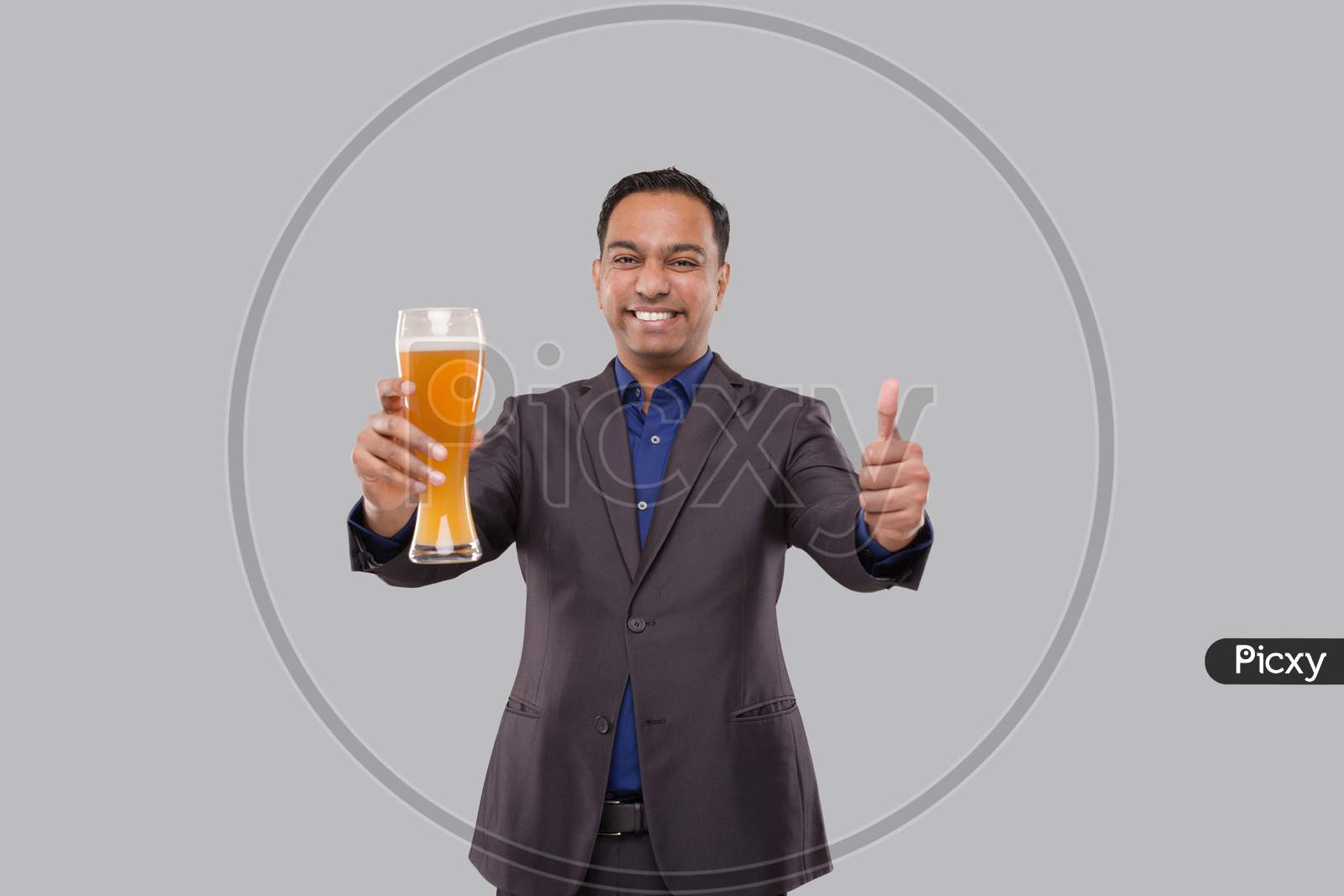 Businessman Holding Beer Glass Showing Thumb Up. Indian Business Man With Beer In Hand