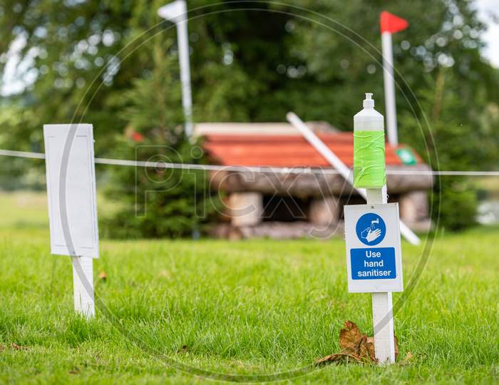 Hand Sanitiser And Covid-19 Reminder Sign At An Outdoor Horse Trials Event