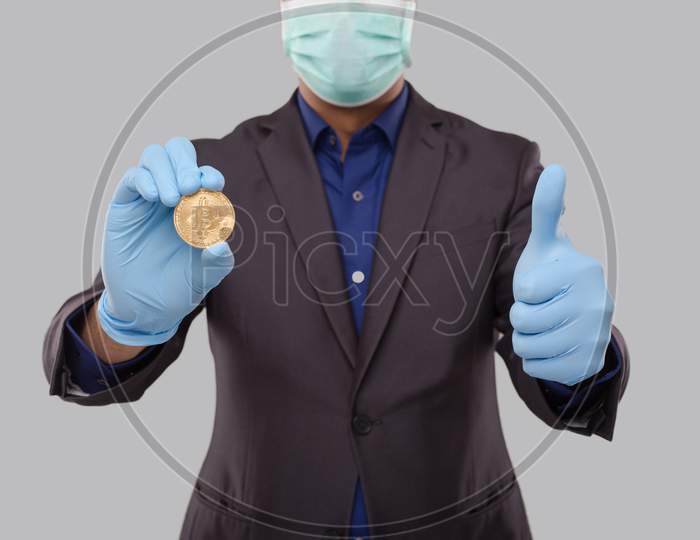 Businessman Showing Bitcoin And Thumb Up Wearing Medical Mask And Gloves. Business Man Cypto Currency.