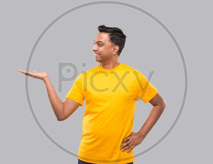 Indian Man Showing To Side Smilling Isolated.