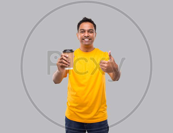Indian Man Holding Coffee To Go Cup Showing Thumb Up Isolated. Man Coffee Take Away Cup In Hands