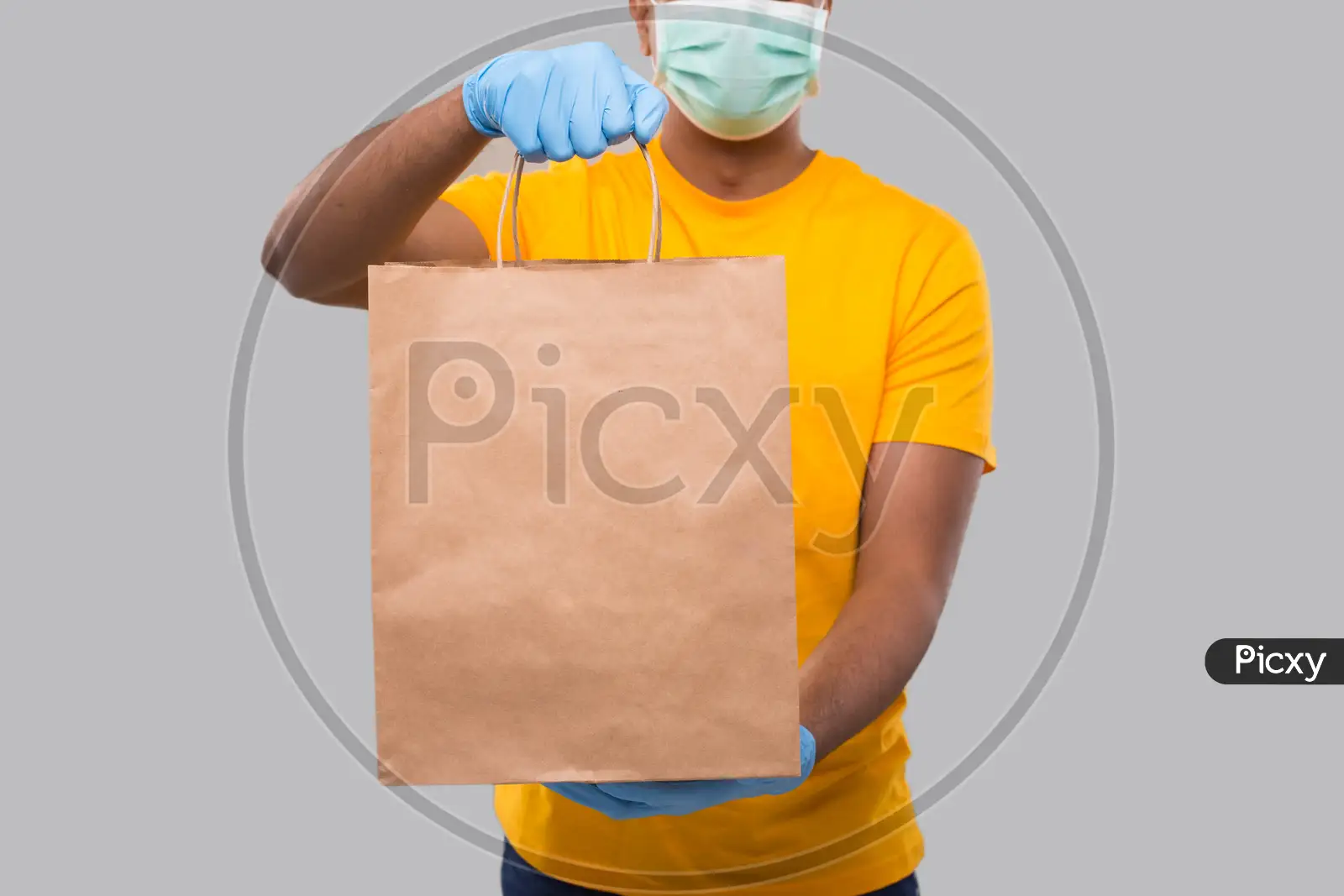 Delivery man delivering grocery bag wearing face mask and gloves