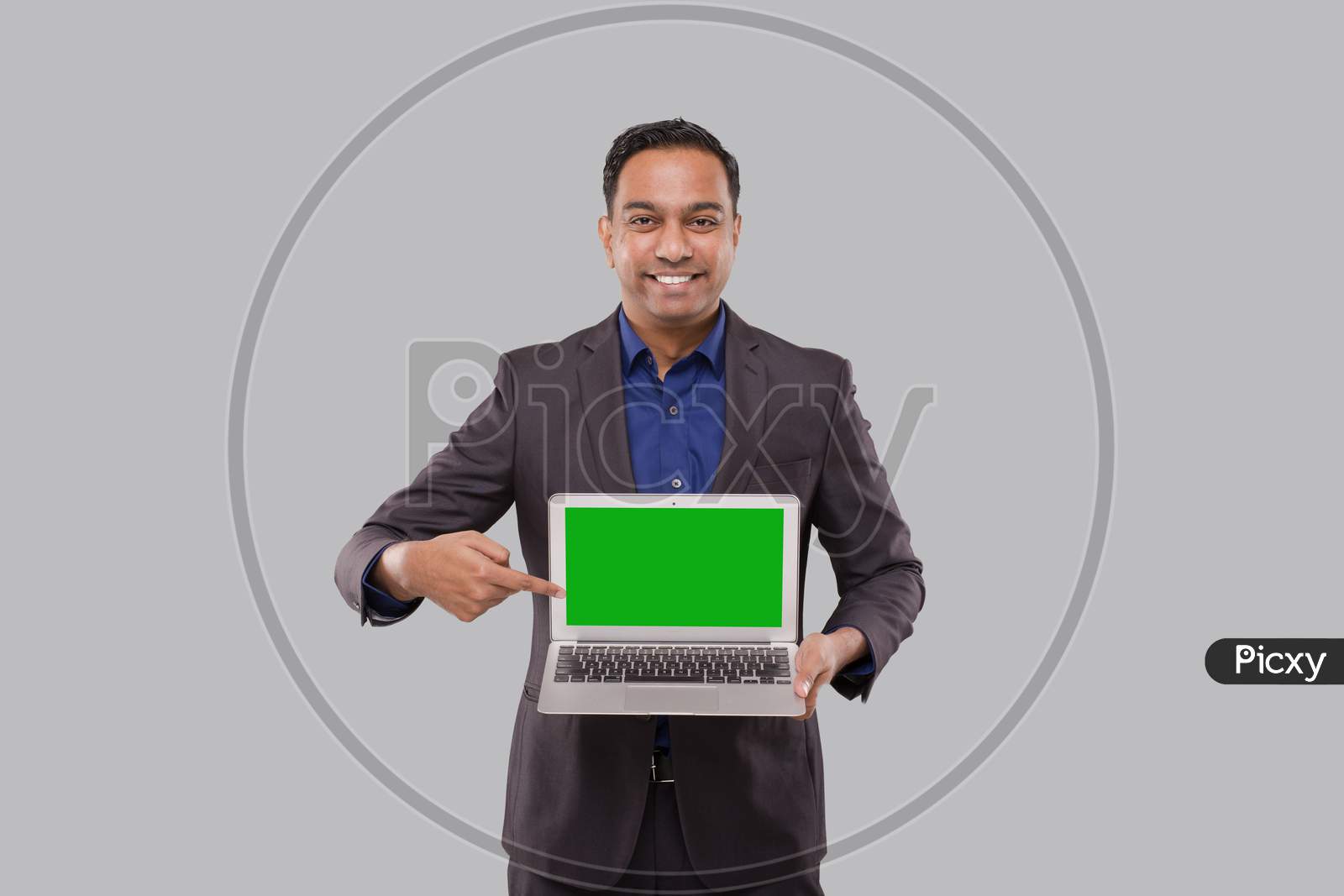 Businessman Pointing At Laptop Green Screen Isolated. Indian Business Man With Laptop In Hands. Online Business Concept