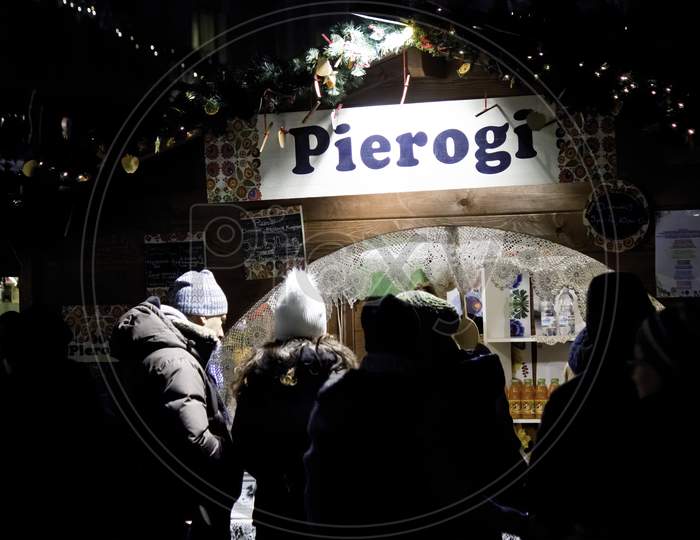 Krakow, Poland - December 08, 2014: Street Photography Of Pierogi Seller In The Mains Center Square
