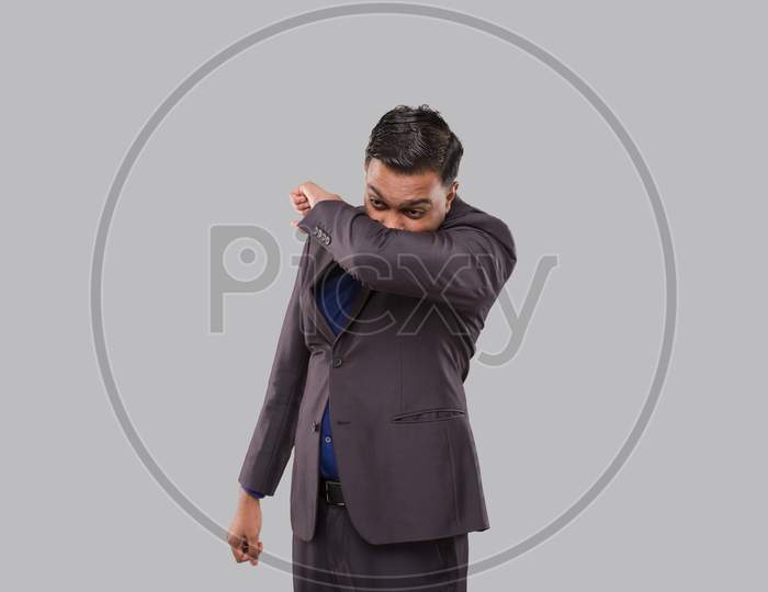 Businessman Sneezing Virus Style. Indian Business Man Sneezing In Elbow.