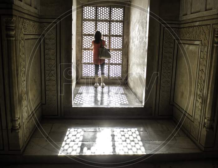 Agra, India - April 10,2014: A Female Tourist Wearing Plastic Bag Shoes Inside Tajmahal Dome And Sun Rays Coming Through Windows