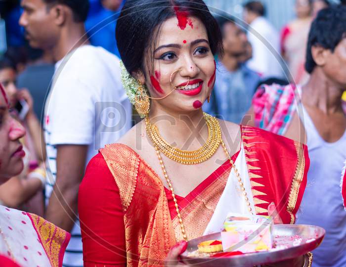 Holi and Durga puja Festival in India. Portrait of an unidentified Bengali woman playing with vermilion or colors on vijay dashami at the Durga puja festival in Kolkata on 8th October 2019.