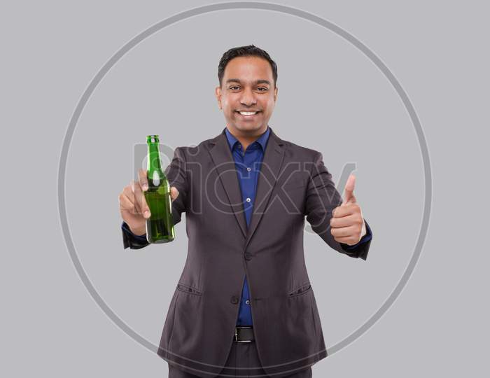 Businessman Holding Beer Bottle Showing Thumb Up. Indian Business Man With Beer Bottle In Hand.