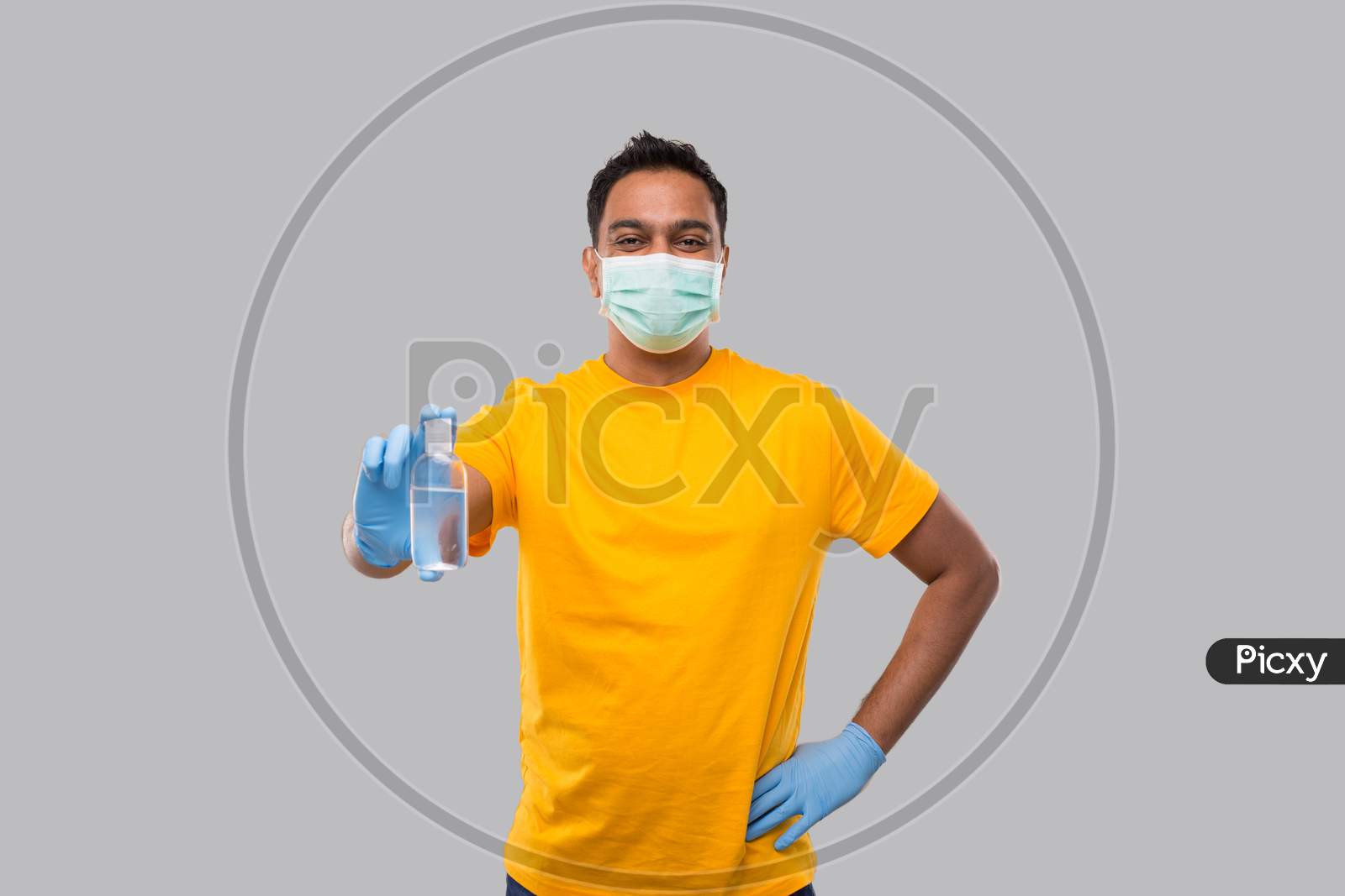 Indian Man Showing Hands Sanitizer Wearing Medical Mask And Gloves Isolated. Indian Man Holding Hand Antiseptic