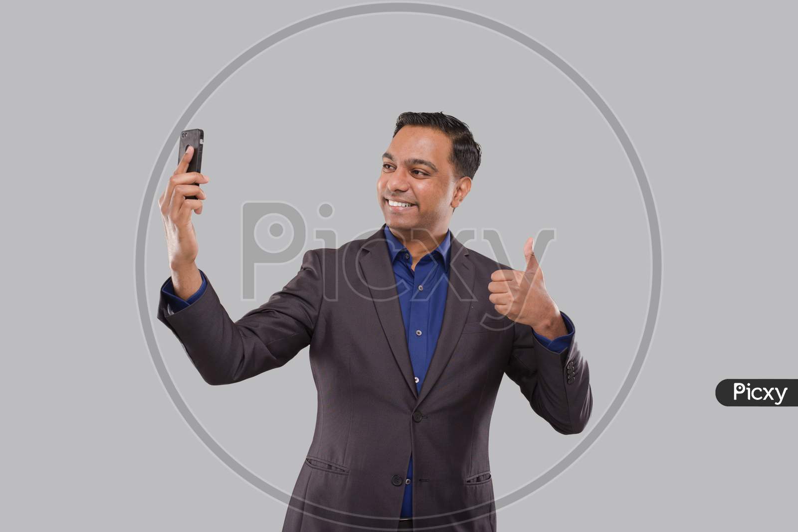 Businessman Having Video Call On Phone Showing Thumb Up Isolated. Indian Man Businessman Video Call. Business Online. Businessman Using Phone. Indian Business Man Standing Full Length