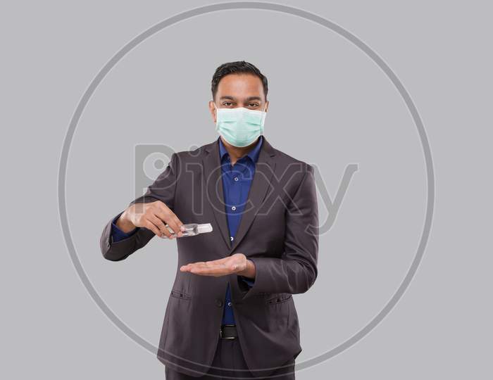 Businessman Wearing Medical Mask Using Hand Sanitizer. Indian Business Man Using Hands Antiseptic
