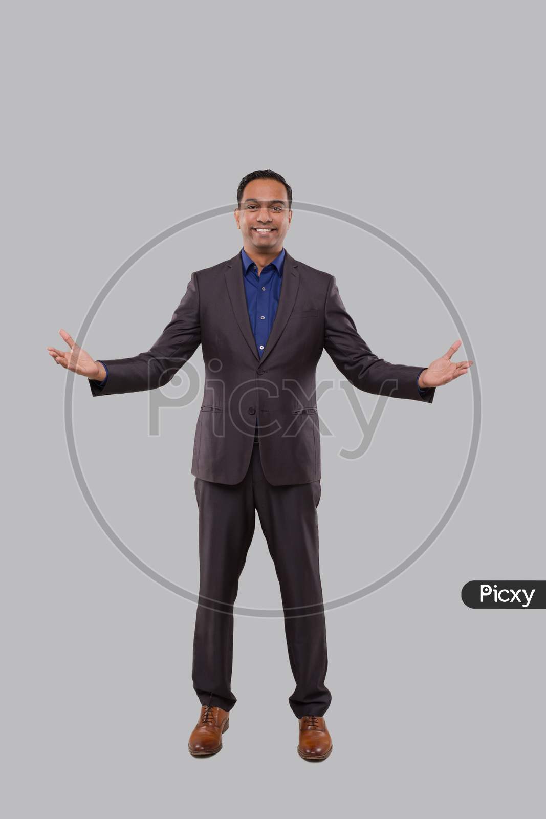 Businessman Hands To Sides Welcome Gesture Isolated. Indian Businessman Standing Full Length