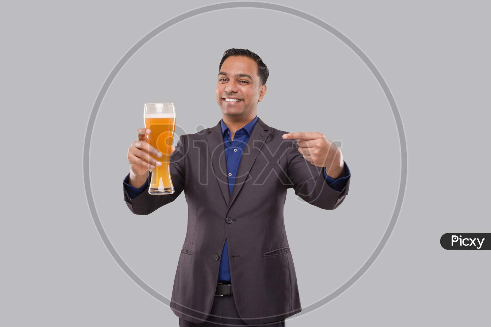 Businessman Pointing At Beer Glass. Indian Business Man With Beer In Hand