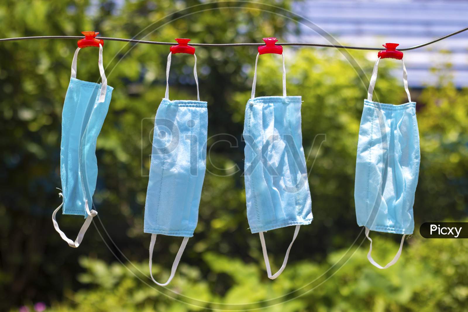selective focus of face masks hanging on an wire after wash.