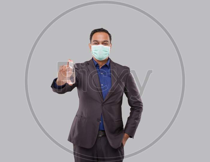 Businessman Showing Hands Sanitizer Wearing Medical Mask. Indian Business Man Holding Hand Antiseptic