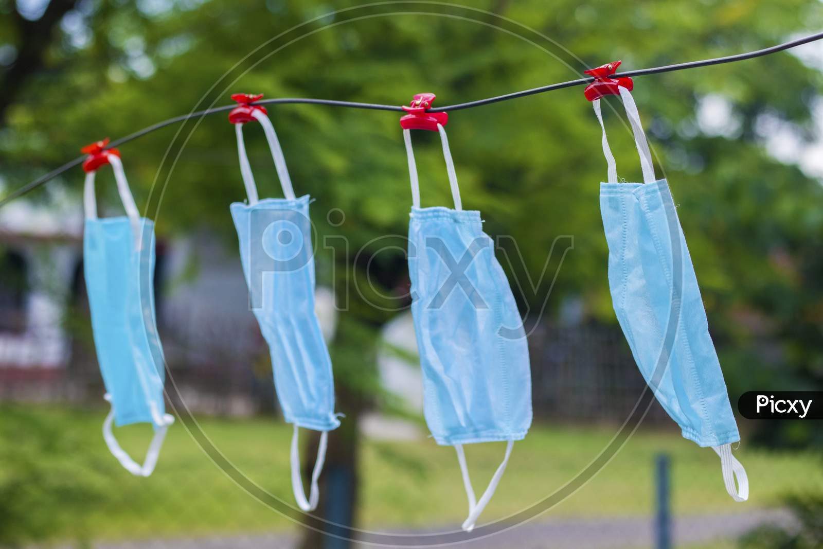 selective focus of face masks hanging on an wire after wash.