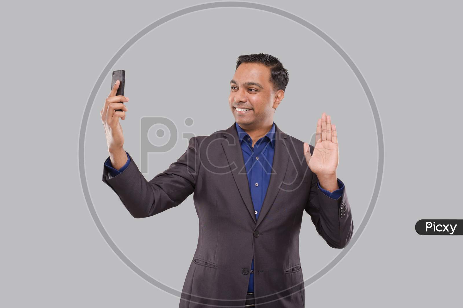 Businessman Having Video Call On Phone Waving Isolated. Indian Man Businessman Video Call. Business Online. Businessman Using Phone. Indian Business Man Standing Full Length