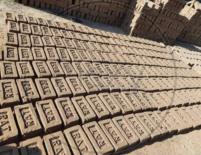 Raw brick laid out in stacks for drying.