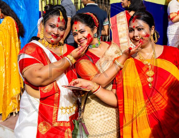 Holi Celebration and Durga puja Festival in Indian. Married and Unmarried women playing with vermilion or colors on vijay dashami at the bagbazar Durga puja,kolkata on 8th October 2019.