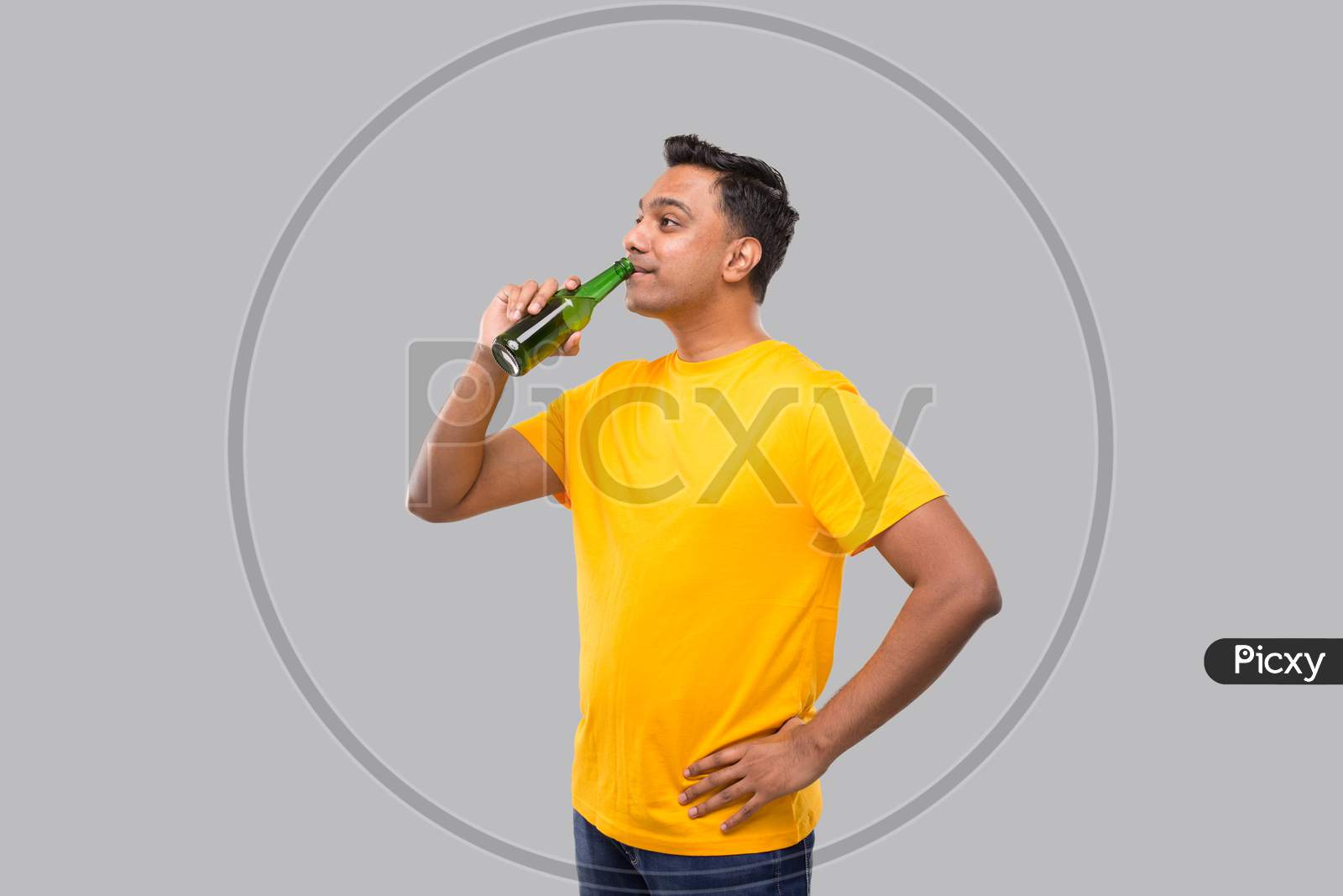 Indian Man Drinking Beer From Beer Bottle Isolated.