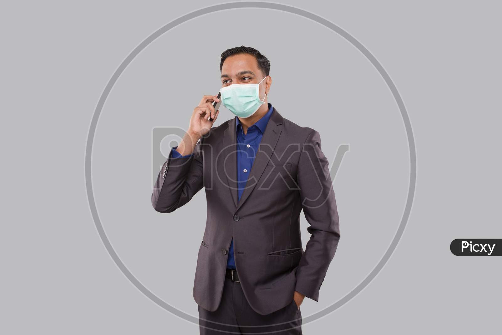Businessman Talking On Phone Wearing Medical Mask Isolated. Indian Business Man With Phone In Hand