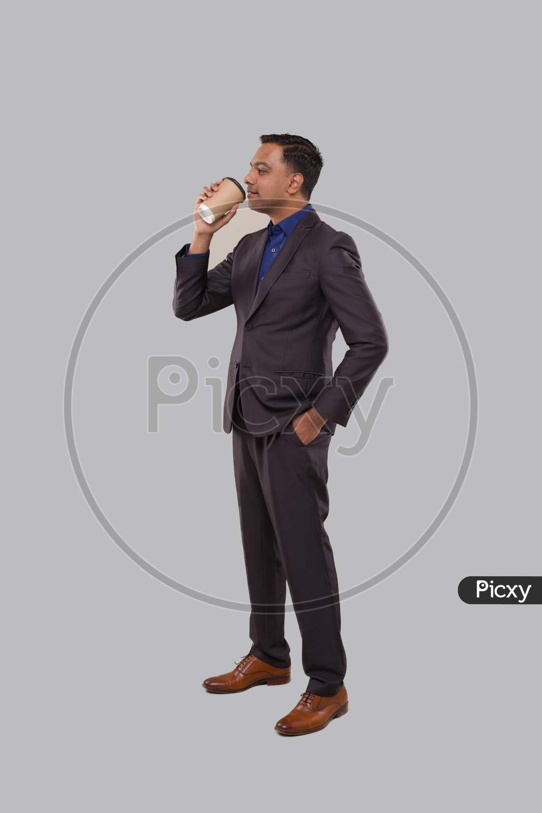 Businessman Drinking Coffee From To Go Cup Isolated. Indian Business Man With Coffee Take Away Cup In Hands