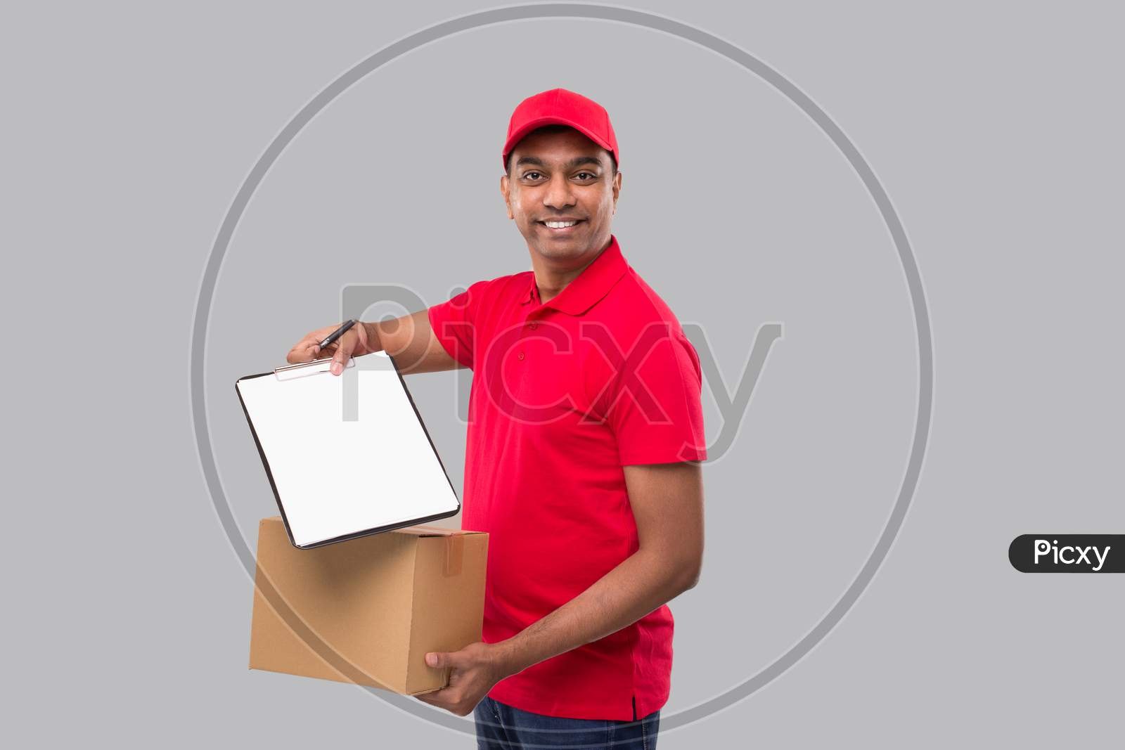 Delivery Man Showing Clipboard Holding Box Watching In Camera. Indian Delivery Boy Clipboard Signature
