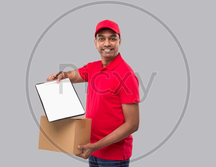 Delivery Man Showing Clipboard Holding Box Watching In Camera. Indian Delivery Boy Clipboard Signature