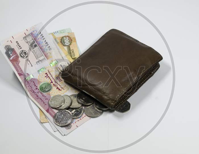 A Wallet And Uae Dirhams And Coins With White Background