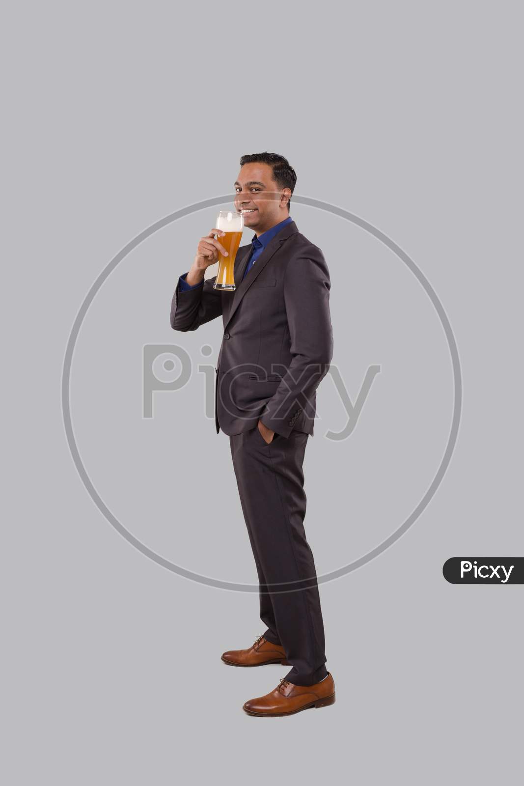 Businessman Drinking Beer From Glass. Indian Business Man Standing Full Length With Beer In Hand