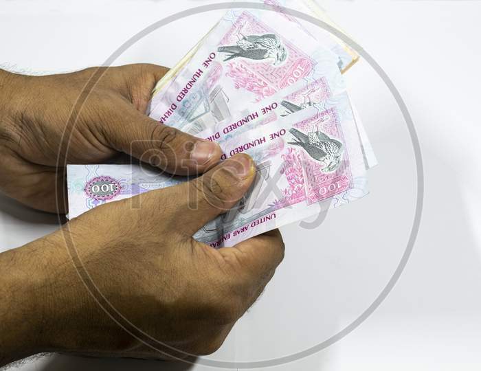 A Man Counting Uae Currency In White Background, Uae Dirhams,