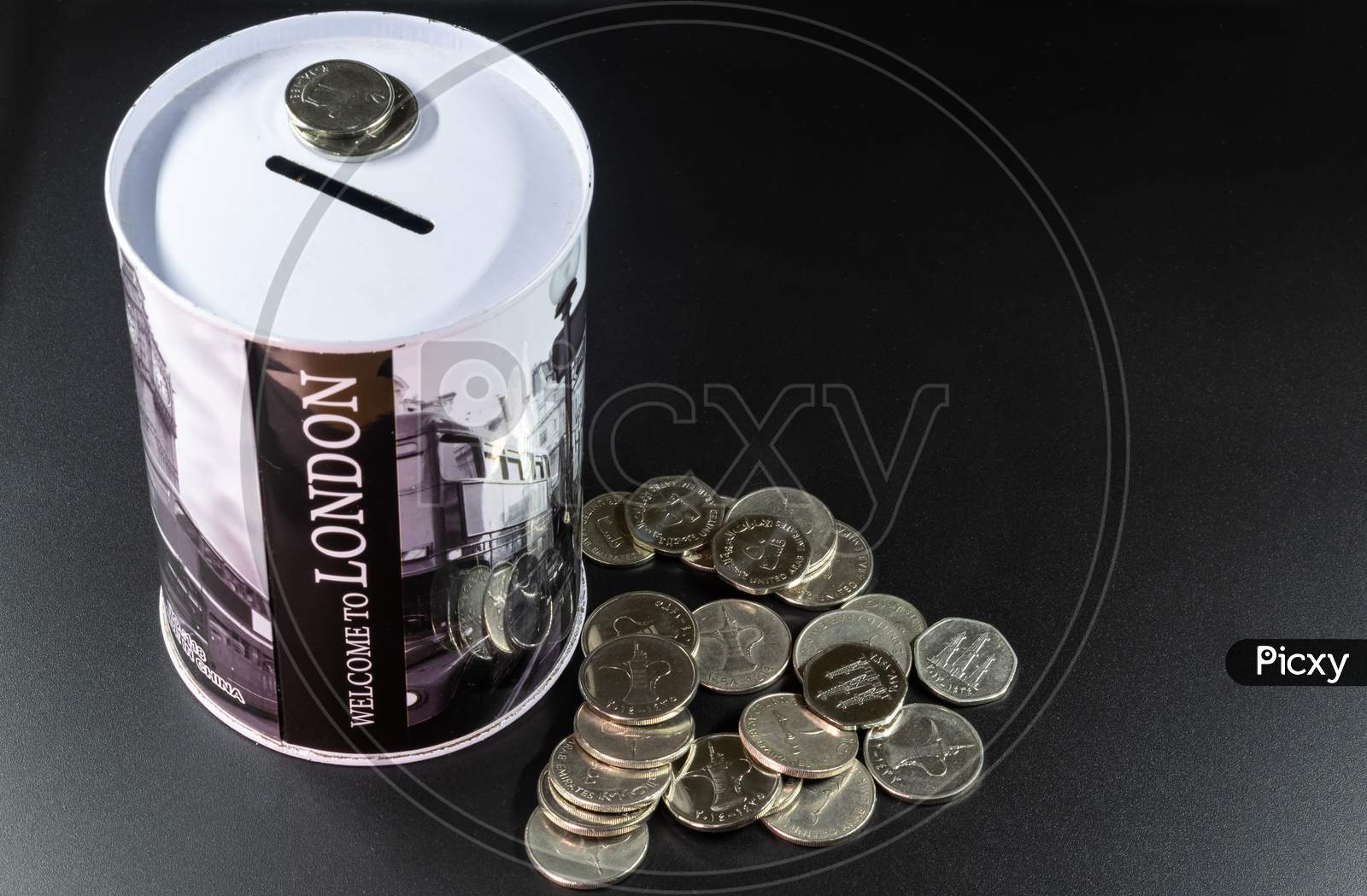 Image of A Coin Collection Box And Some Coins In A Black