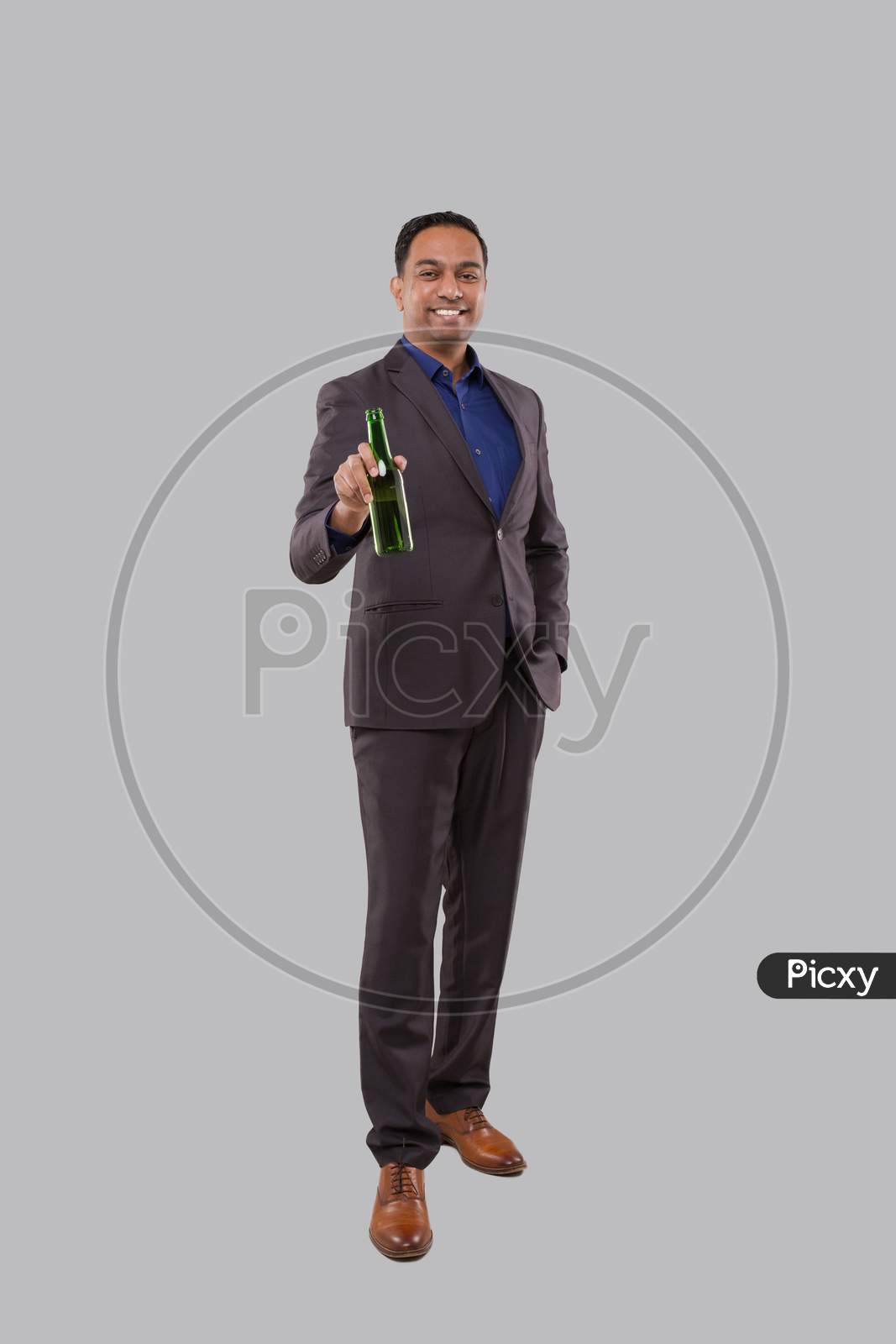Businessman Holding Beer Bottle. Indian Businessman Standing Full Length.