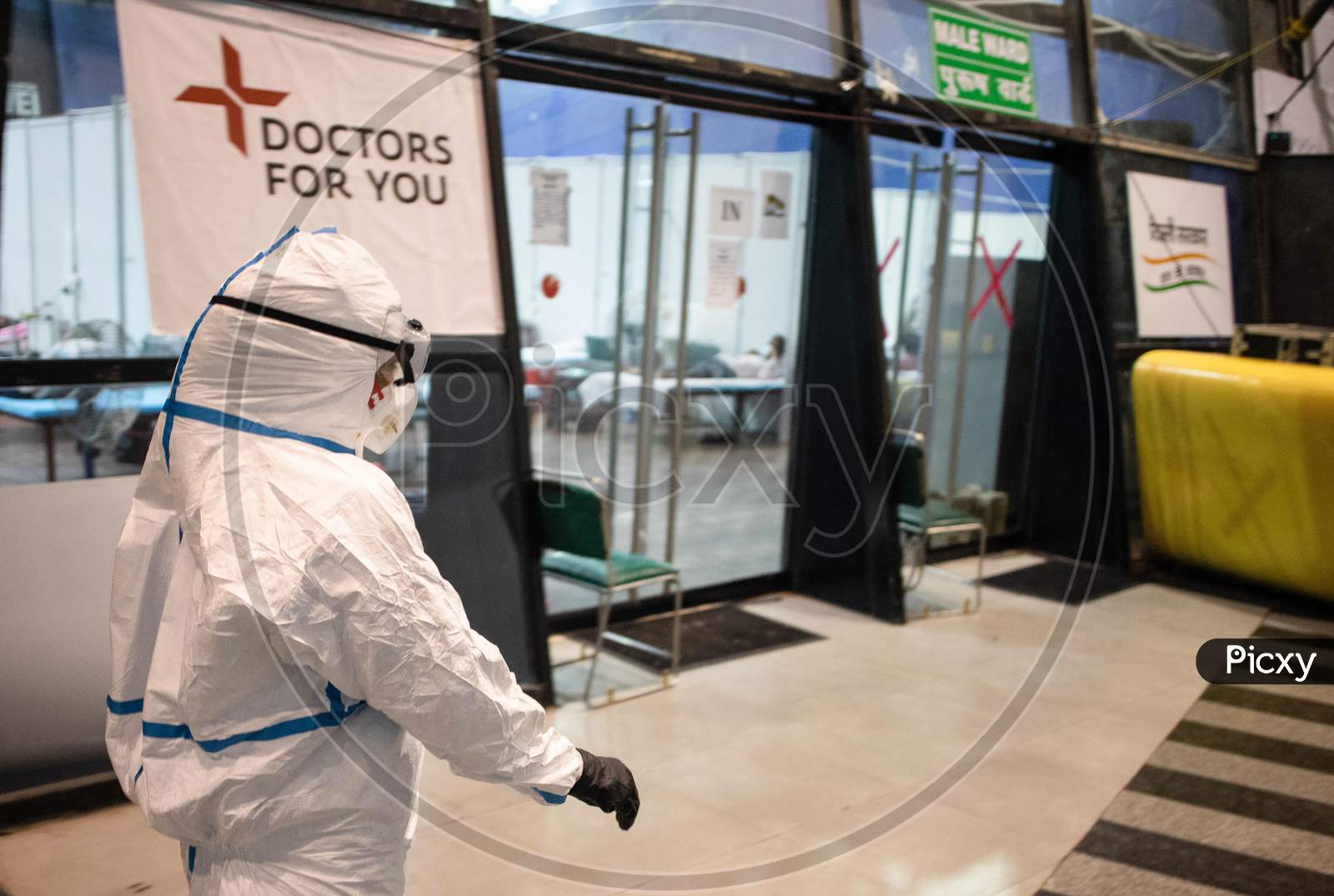 A doctor wearing a PPE suit takes round at the Common Wealth Games stadium which has been converted into a Coronavirus Care Centre in New Delhi on July 17, 2020